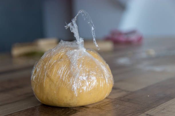 Homemade pasta dough wrapped in plastic food wrap