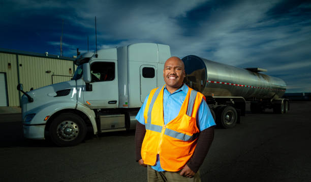 istock Friendly Truck Driver Posing Next to Truck with Hands on Hips 1240542371