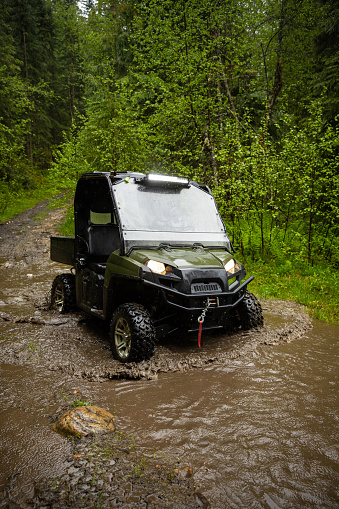 Offroad pickup truck on top of the mountain. Sunny day in the mountains. Exploring the beauty in nature with vehicles of terrain.