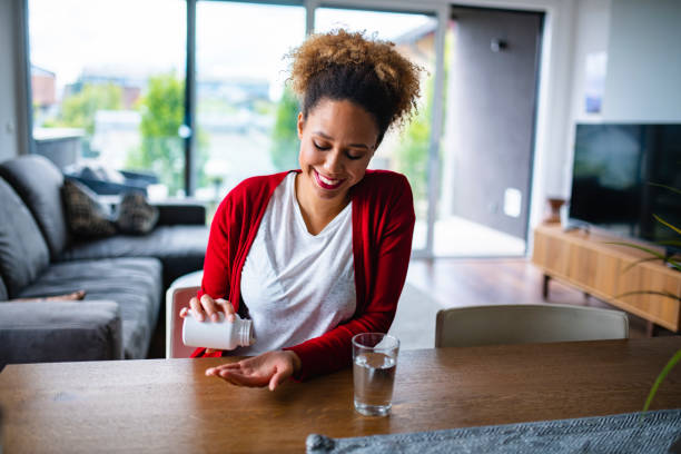 istock Mixed Race Woman in her late 20s taking nutritional supplements 1240570270