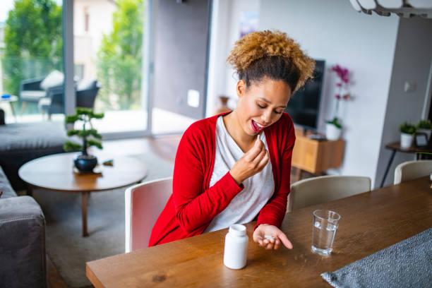 istock Mixed Race Woman in her late 20s eating nutritional supplements 1240571298