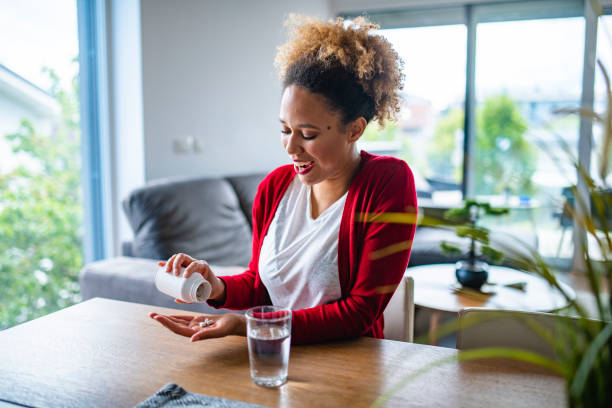 istock Mixed Race Woman in her late 20s eating nutritional supplements 1240571306