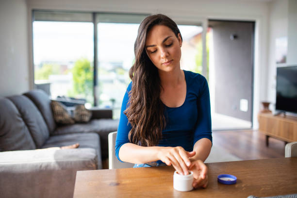 istock Content Caucasian Woman in her 20s applying moisturiser 1240574404