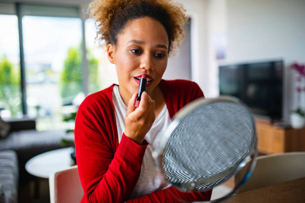 istock Content Mixed Race Woman Applying Lipstick 1240576493