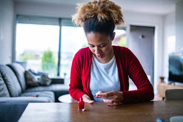 istock Enthusiastic Female Painting Her nails red 1240578033