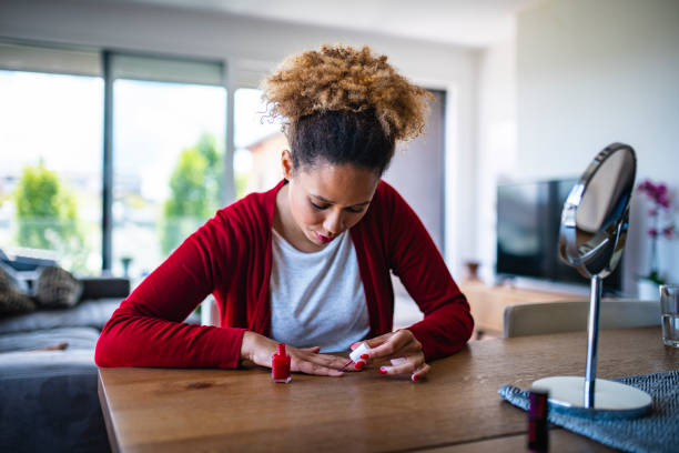 istock Enthusiastic Female Painting Her nails red 1240579082