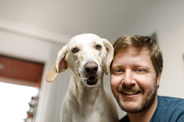 istock Man and dog looking at camera smiling 1240594096
