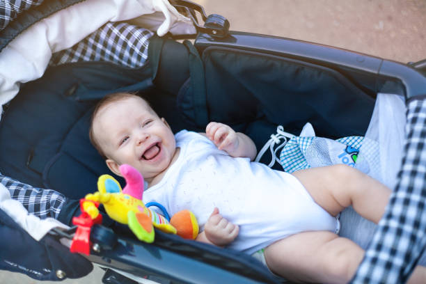 istock a small child in a stroller on a walk with mom and dad 1240599278