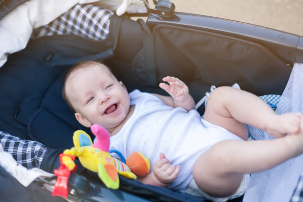 istock a small child in a stroller on a walk with mom and dad 1240599782