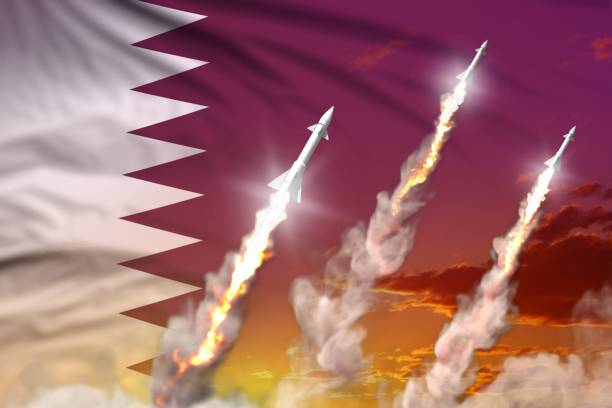 istock Modern strategic rocket forces concept on sunset background, Qatar ballistic warhead attack - military industrial 3D illustration, nuke with flag 1240621039