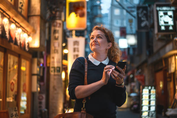 istock Happy Caucasian Traveler Using Smart Phone as Guide in Tokyo 1240647290