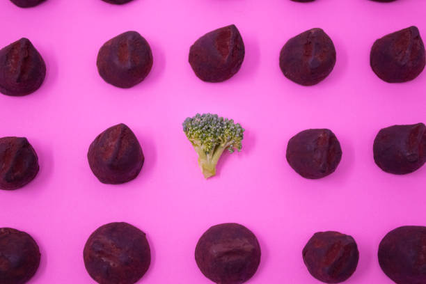 Vibrant broccoli stands out amongst rows of chocolate