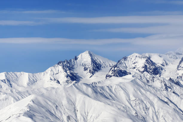 istock High snowy mountains and blue sky with clouds 1240647894
