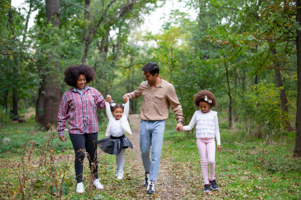 istock Happy family walking along a path in the woods 1240664295