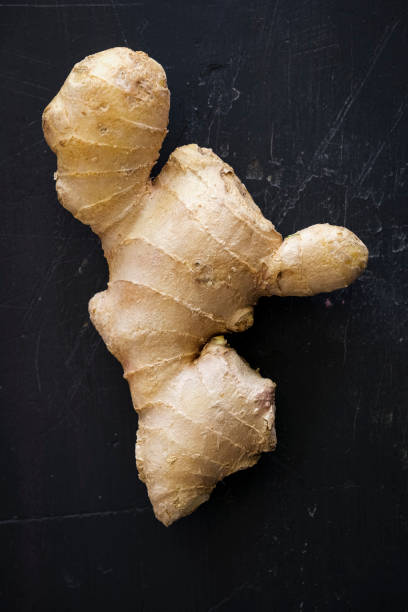 istock Ginger Rhizome on a Black Wooden Surface 1240678522