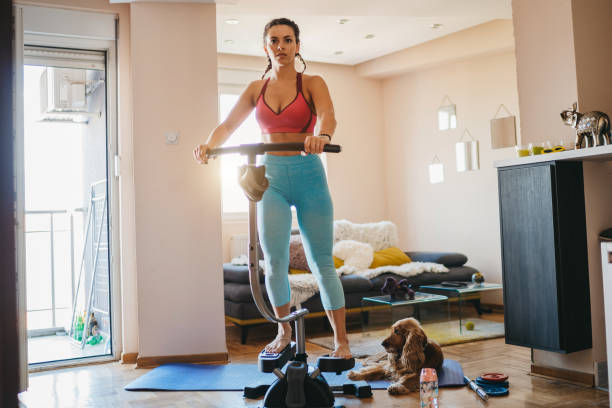 istock Young woman exercising while at home 1240696574