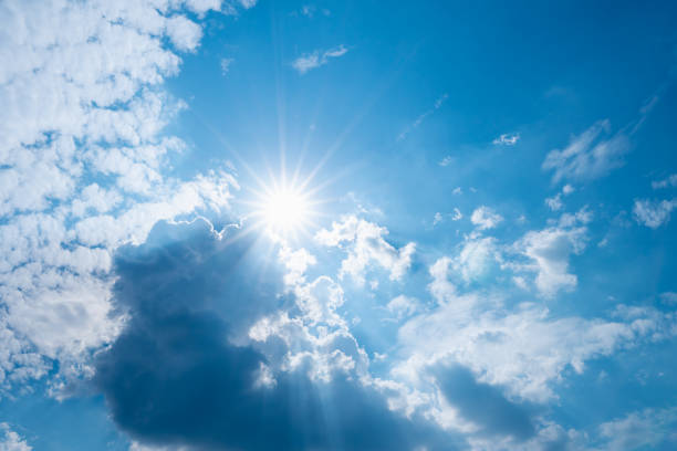 istock blue sky with clouds and sun shines bright in the day 1240765508