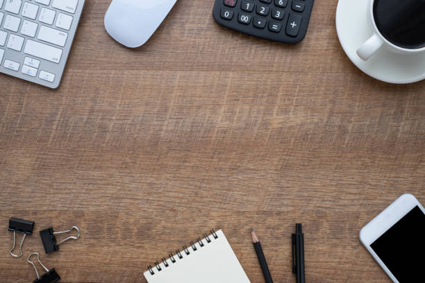 istock Workspace in office with wood table. Top view from above of keyboard with notebook and coffee. Desk for modern creative work of designer. Flat lay with blank copy space. Business and finance concept. 1240844677