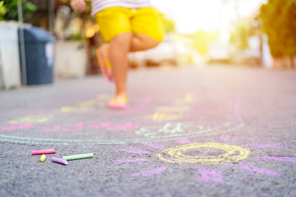 istock Asian children use chalk to write on the floor 1240883594