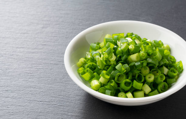 istock Carved green onions placed on a black background 1240901984
