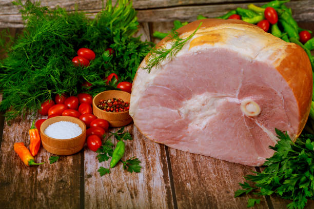 istock Pork ham with fresh parsley, dill and tomato. 1240941785