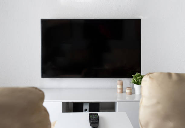 istock Lcd screen , leather and remote control on the table in interior living room. Watching television at home cocnept. 1240943308