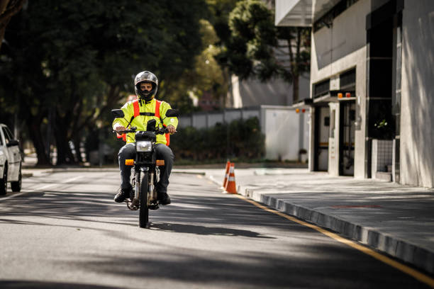 istock Delivery biker arriving at destination - motoboy 1240951005