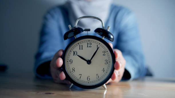 istock Woman holding alarm clock, time management concept, selective focus on clock 1240968240