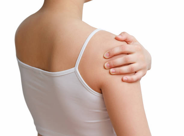 istock a woman massages her arm with a sick shoulder. rear view 1241003338