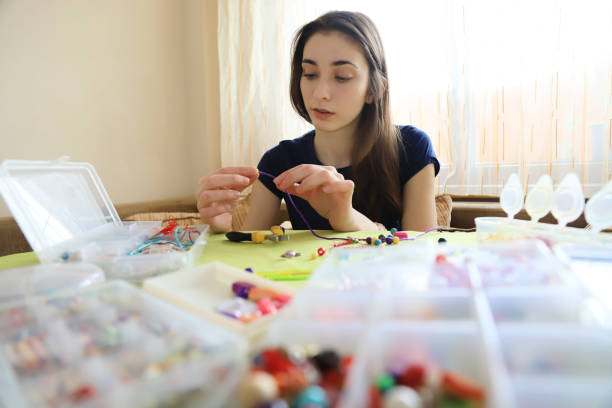 istock Young woman making bead bracelets 1241031381