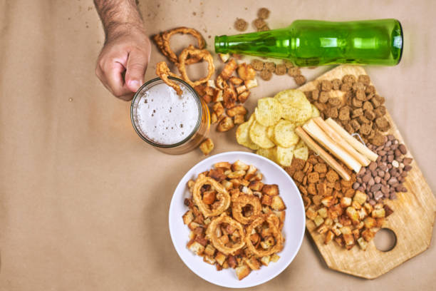 istock Drinking beer. Table full of beer snacks 1241049691