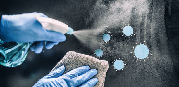 istock Cleaning home table disinfecting spray spraying on surface to sanitize COVID-19 prevention sanitizing for aerosol droplets. Coronavirus sanitize protection. Panoramic banner 1241052262