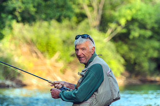 Fisherman with caught fish on green background