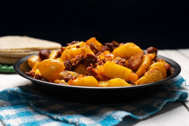 Traditional mexican potatoes with chorizo on white background