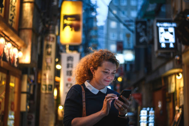 istock Smiling Caucasian Tourist Using Smart Phone for Travel Tips 1241074867