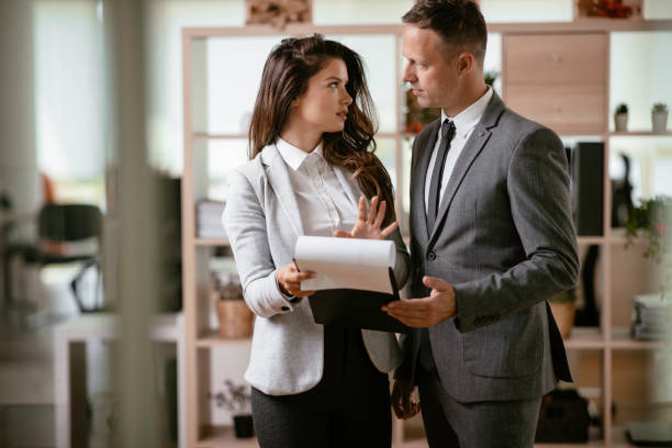istock Businessman and businesswoman working on a project. 1241119907