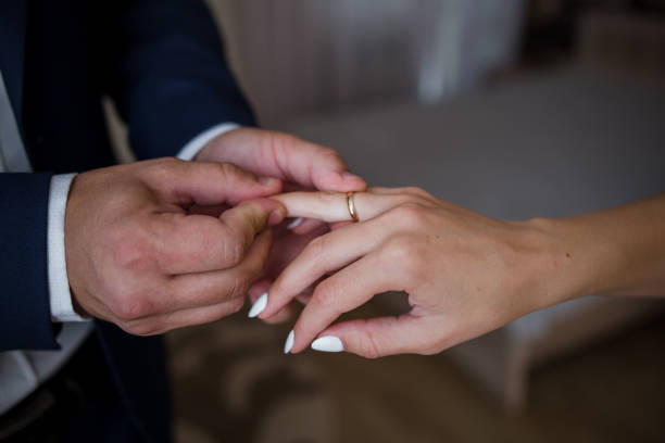 istock the bridegroom puts the ring on the bride’s hand 1241140975