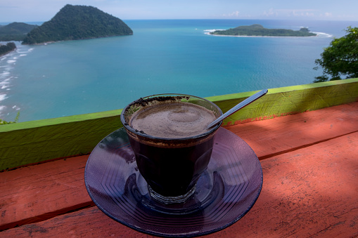 The moment will not be forgotten while enjoying a cup of coffee on the summit of Mount Geurutte, Lamno, Aceh Jaya, Aceh (31-Mai-2020).  Geurute with the beauty of the blue sea as far as the eye can see with a small group of mountains decorated with a special attraction.  Apart from this peak when dusk will be presented the charm of the sunset.  The area of ​​Mount Geurutee is between the border of Aceh Besar and Aceh Jaya, facing the Indian Ocean.