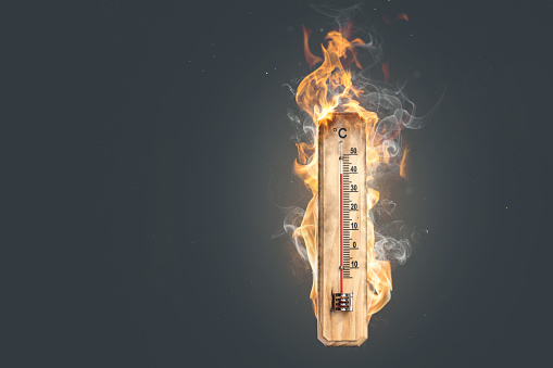 A thermometer on fire with actual flames while showing a high temperature in celsius.