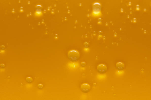 istock Golden water drops on an yellow background 1241156649