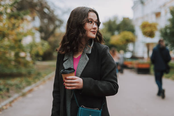 istock Beautiful lady with coffee to go turning her head 1241162985