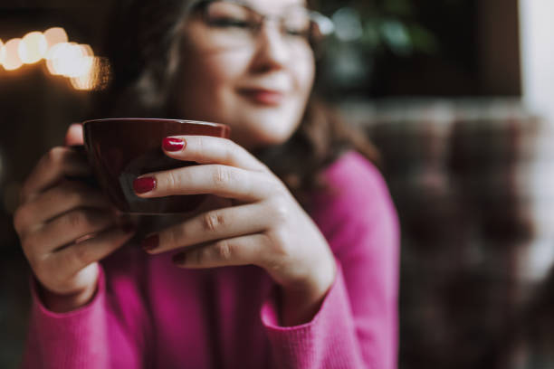 istock Smiling young female enjoying the day in cafe 1241163573
