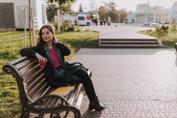 istock Smiling young female holding coffee on the square 1241173726
