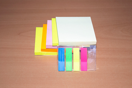 side view of bright color packs of stickers on wooden surface