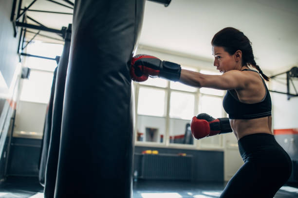 istock Young woman kickboxer training 1241184901