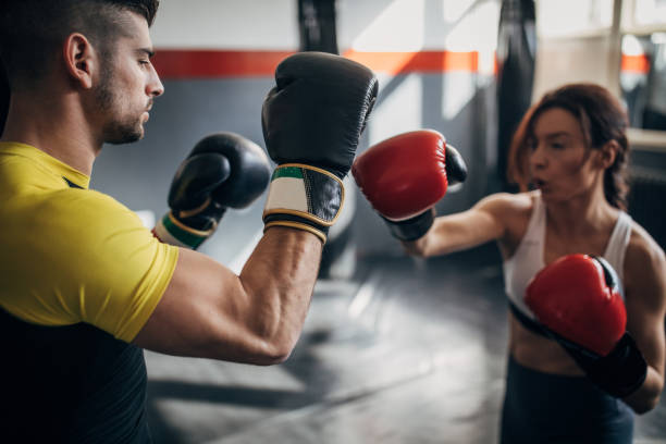 istock Fit woman kickboxer sparring with her coach 1241201890