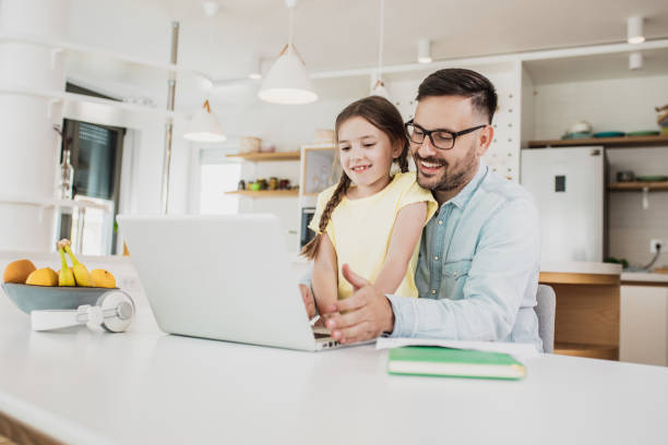 istock Father working from home with his daughter in his lap 1241218234