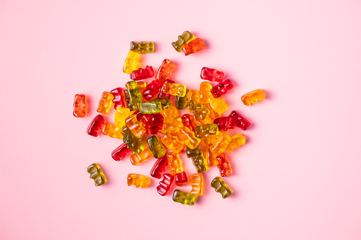 Gummy bears, jelly candy. Colorful bonbons on colorful background. Top view.