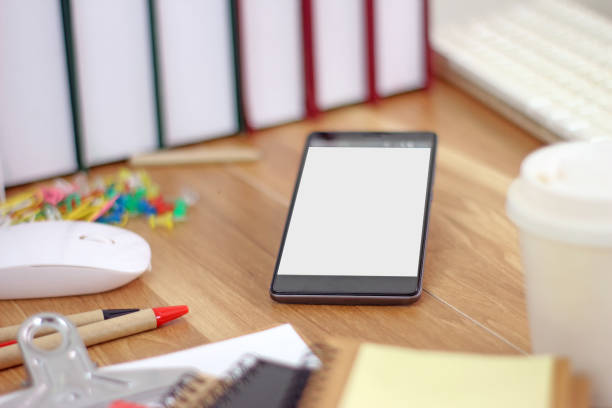 Workspace with smartphone and office equipments on wood desk work background