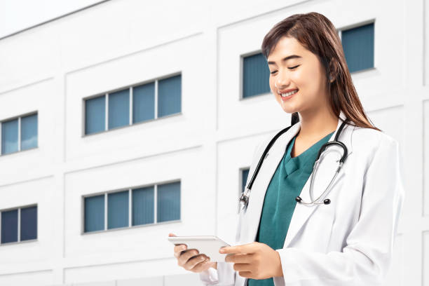 istock Asian Doctor woman with stethoscope using a tablet 1241264437